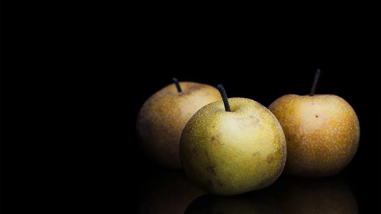 Sliced Nashi pear next to an apple, showing the crisp apple-like texture of Australian Nashi pears